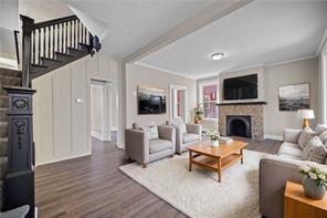 9600 Frankstown Road Pittsburgh, PA 15235 - Photo 3 of 28 a living room with furniture a flat screen tv and a fireplace