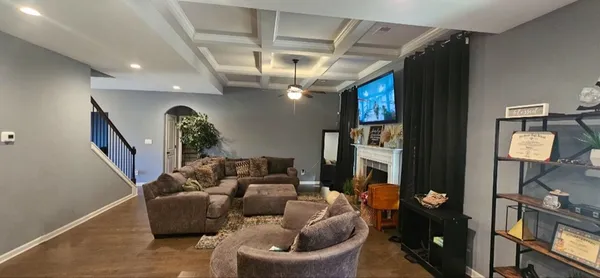 a living room with furniture and a chandelier