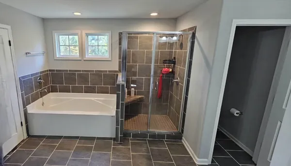 a bathroom with a bathtub and a shower
