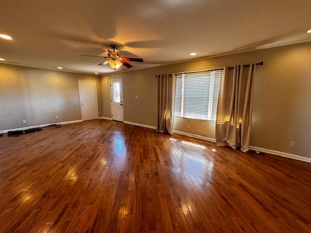 442 Shady Grove Road Flintville, TN 37335 - Photo 5 of 44 a view of an empty room with wooden floor and a ceiling fan