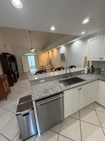 a kitchen with stainless steel appliances granite countertop a sink and a stove