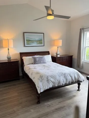 a bedroom with a bed and a night stand