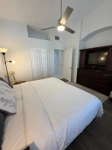 a bedroom with a bed and a flat screen tv