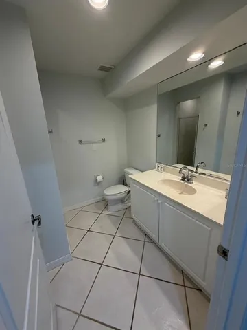 a bathroom with a sink a toilet and mirror