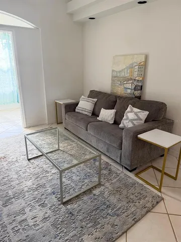 a living room with furniture and a rug