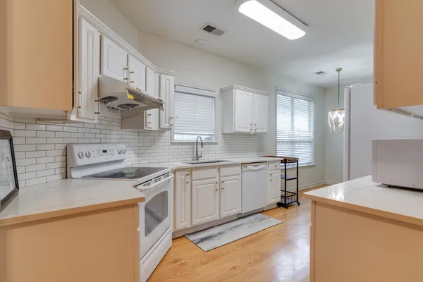 a kitchen with a sink stove and cabinets