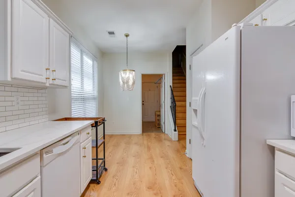 a kitchen with a sink a refrigerator and window