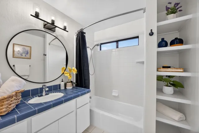 a bedroom with two large bed and a window