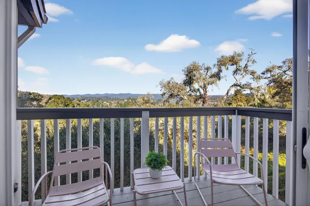 a balcony with wooden floor and outdoor space