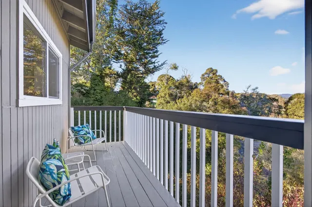 a view of a chairs and table in the backyard