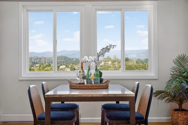 a dining room with furniture window and wooden floor