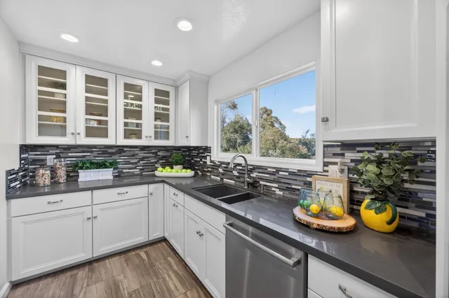 a kitchen with a sink and white cabinets