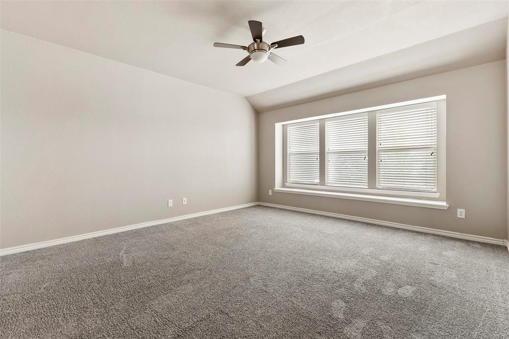 6522 Portside Ridge Lane Dallas, TX 75249 - Photo 20 of 37 Carpeted room featuring a large window with blinds, a ceiling fan, and neutral paint