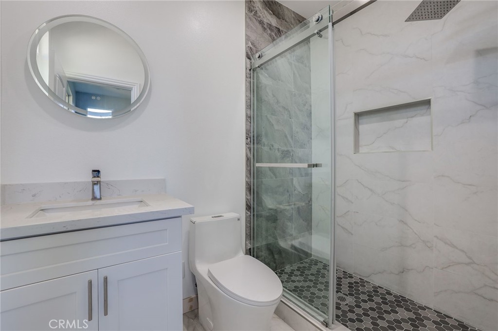 11875 Wisteria Avenue, Unit ADU Fountain Valley, CA 92708 - Photo 12 of 14 a bathroom with a toilet a sink and shower