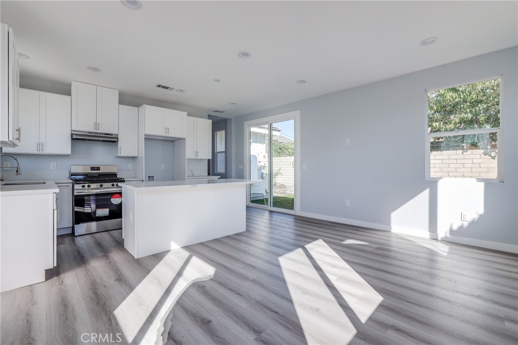 11875 Wisteria Avenue, Unit ADU Fountain Valley, CA 92708 - Photo 2 of 14 a living room with stainless steel appliances furniture wooden floor and a kitchen view