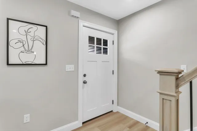 a view of front door with wooden floor