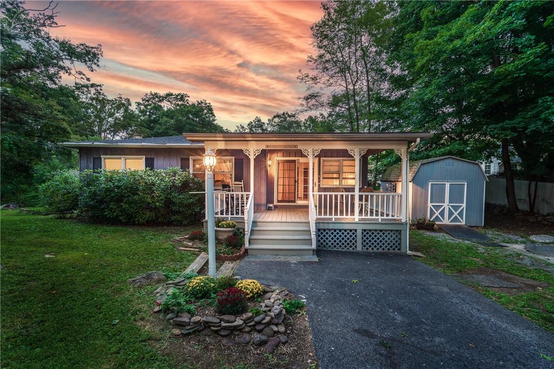 a front view of a house with a garden