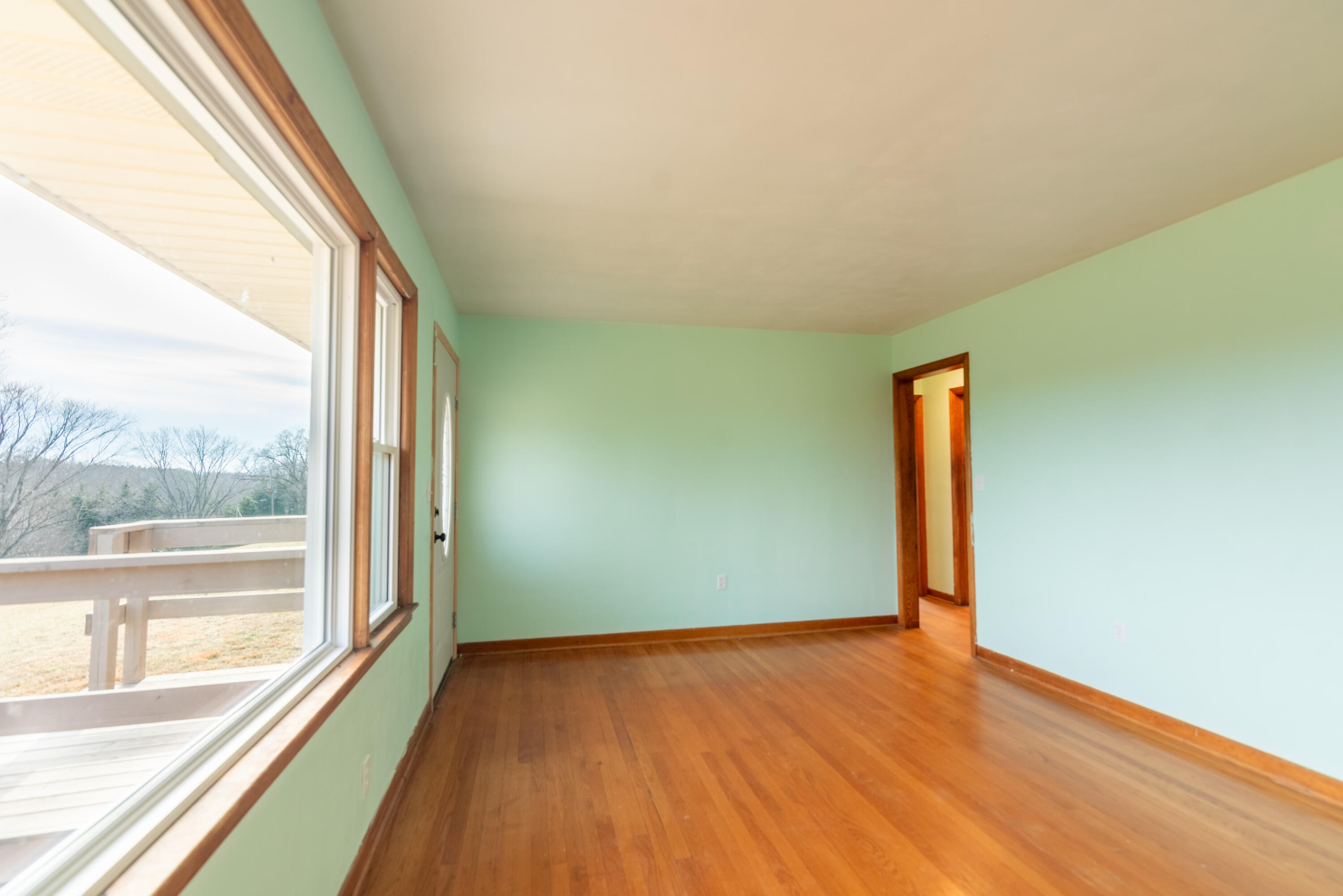 1079 Mountain Valley Road Vinton, VA 24179 - Photo 11 of 29 an empty room with wooden floor and windows