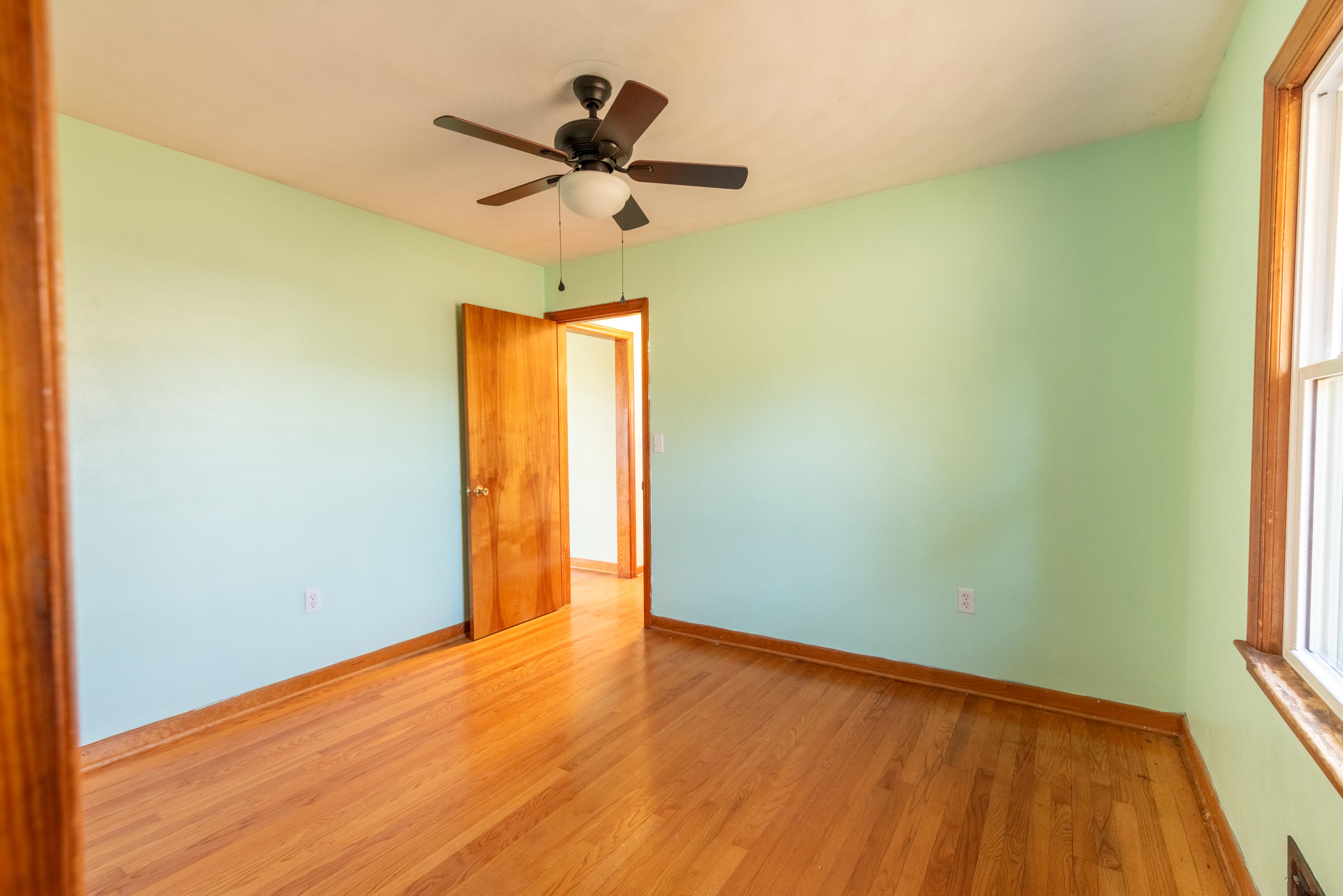 1079 Mountain Valley Road Vinton, VA 24179 - Photo 13 of 29 a view of empty room with wooden floor and fan