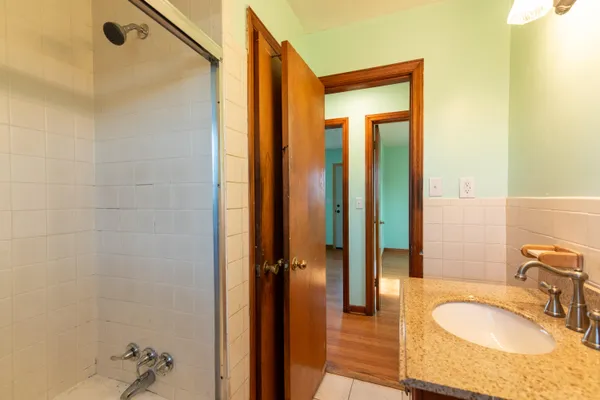 a bathroom with a granite countertop sink and a mirror