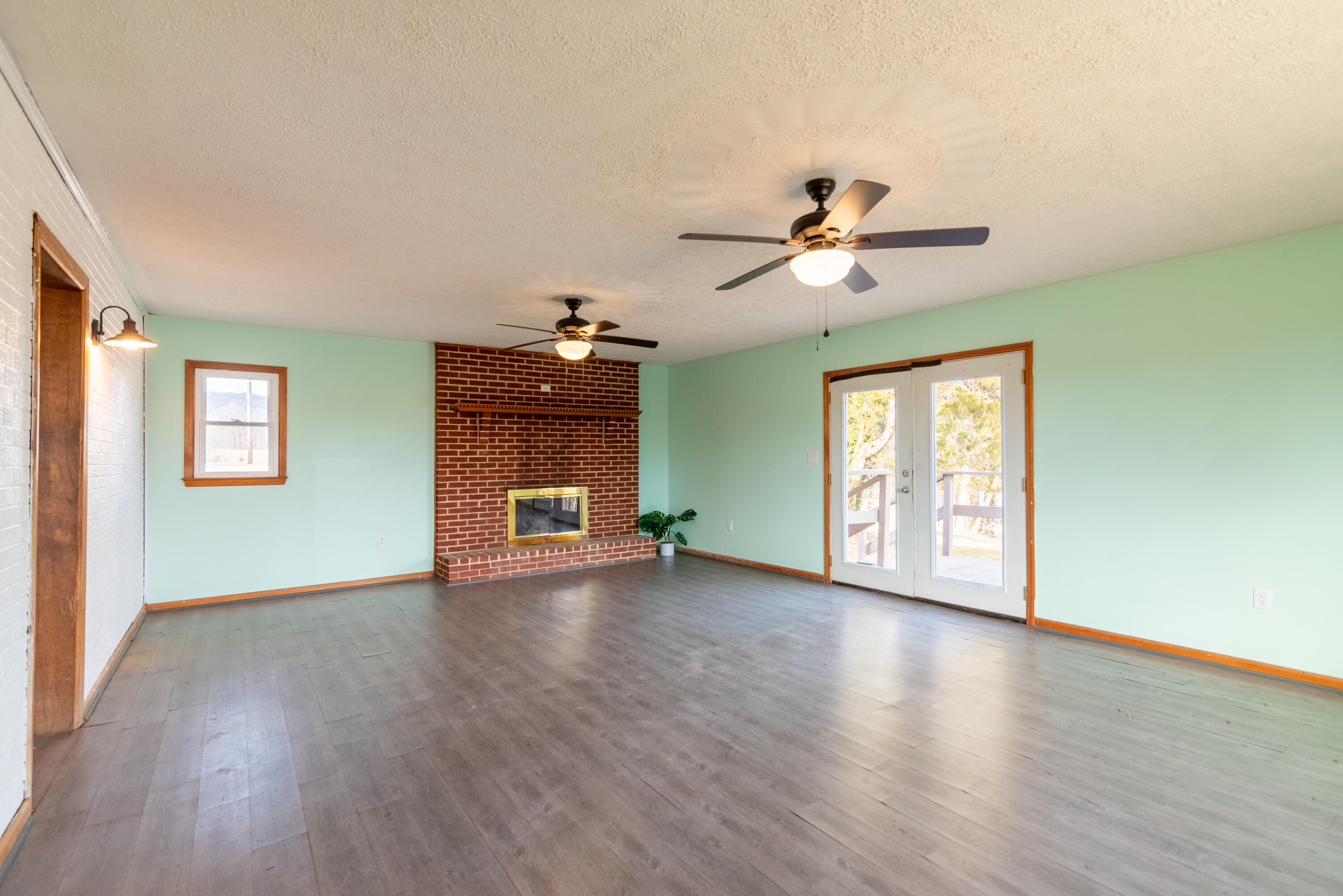 1079 Mountain Valley Road Vinton, VA 24179 - Photo 2 of 29 a view of an empty room with a window and wooden floor