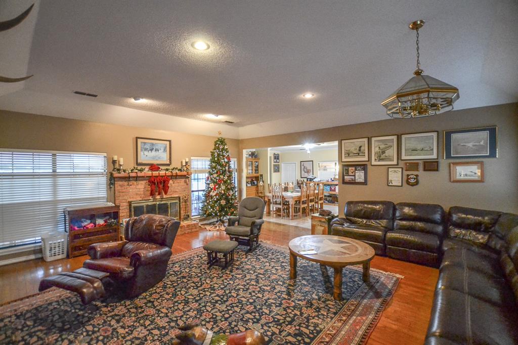 1392 Highway 69 Point, TX 75472 - Photo 36 of 40 a living room with furniture a rug and a chandelier