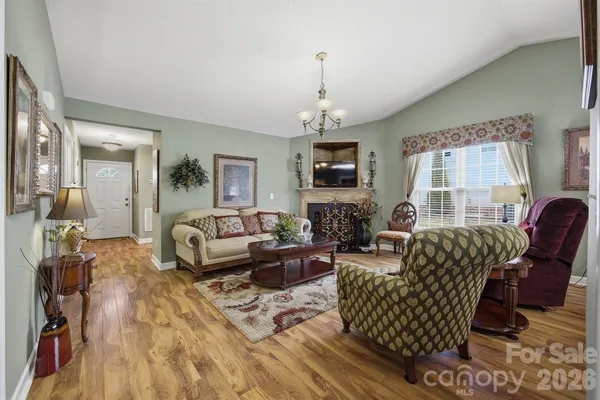 a living room with furniture a fireplace and a flat screen tv