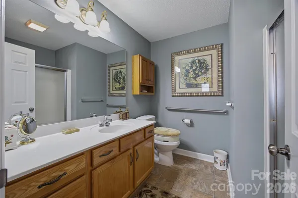 a bathroom with a toilet sink and mirror