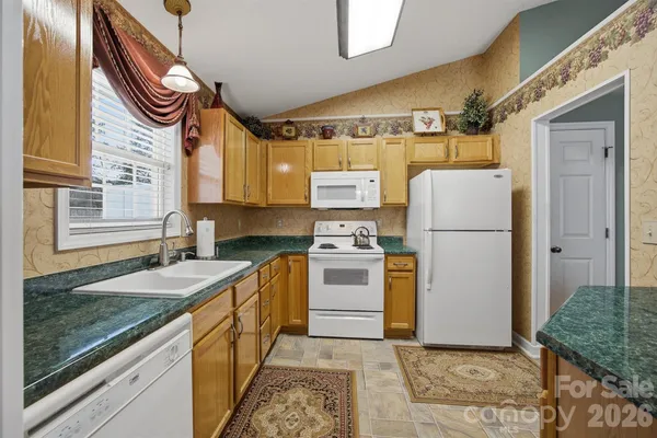 a kitchen with a sink appliances and cabinets
