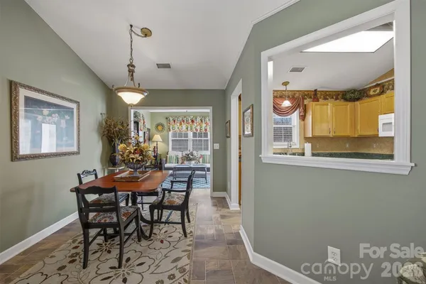 a dining room with furniture and window