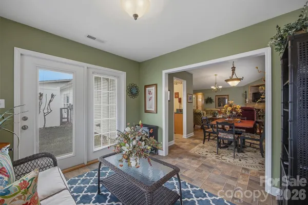 a living room with furniture and a dining table