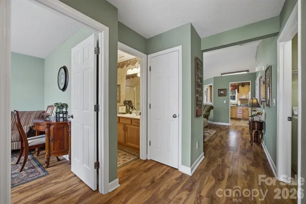 a view of a hallway view with wooden floor and furniture