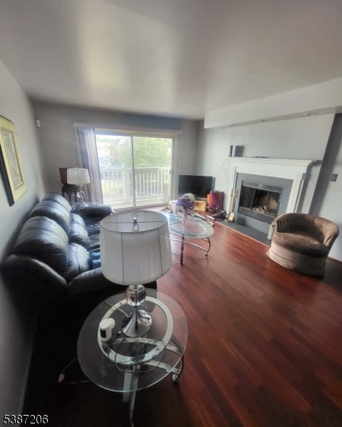 1203 Jesse Way Piscataway, NJ 08854 - Photo 11 of 12 a living room with furniture a fireplace a rug and a large window