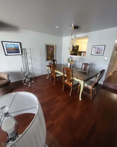 a living room with furniture a dining table and a painting on the wall