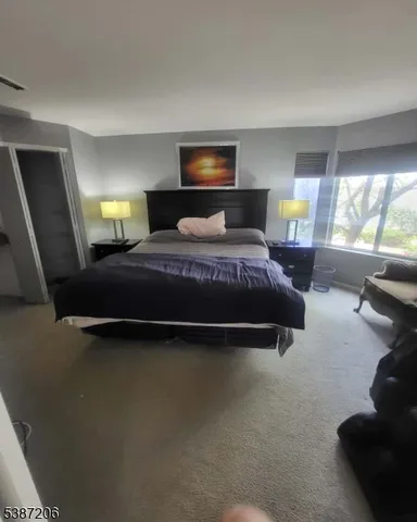 a bedroom with a bed and window