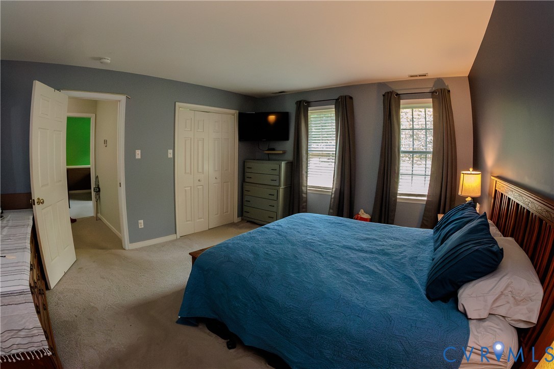 9424 Lockberry Ridge Loop Richmond, VA 23237 - Photo 23 of 24 Carpeted room with a wooden bed frame, two windows