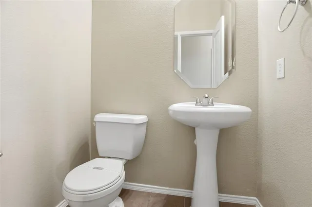 a bathroom with a sink toilet and a mirror