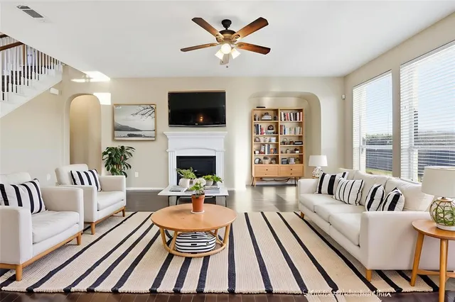a living room with furniture fireplace and a flat screen tv