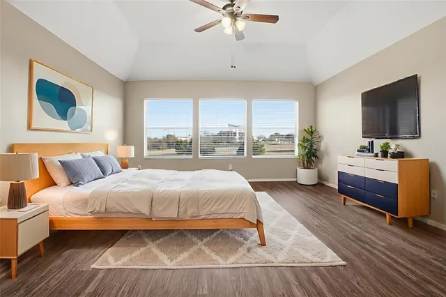 a bedroom with a large bed and a window