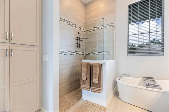 a bathroom with a bathtub and shower