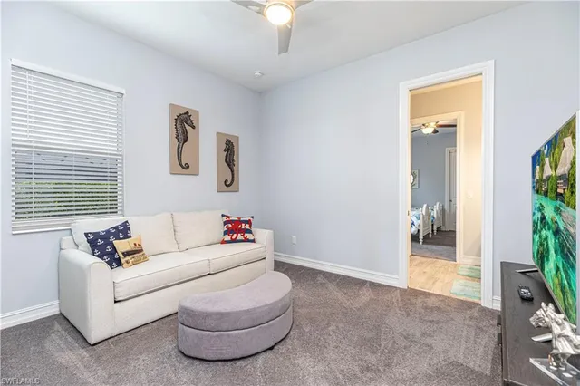 a living room with furniture and a potted plant