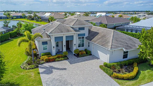 an aerial view of a house with a yard and potted plants