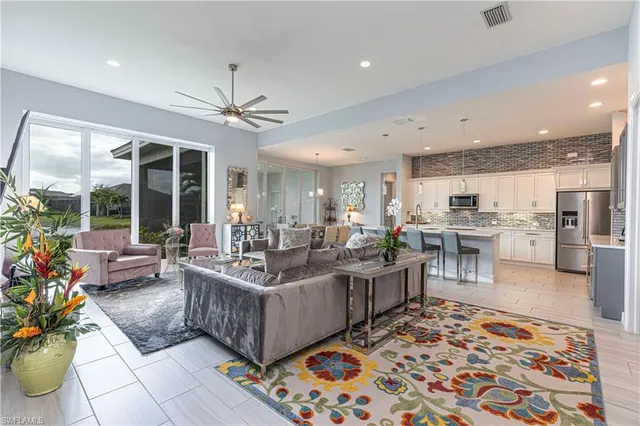 a living room with furniture fireplace and a large window