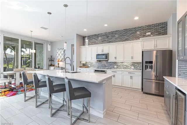 a kitchen with appliances a sink and cabinets