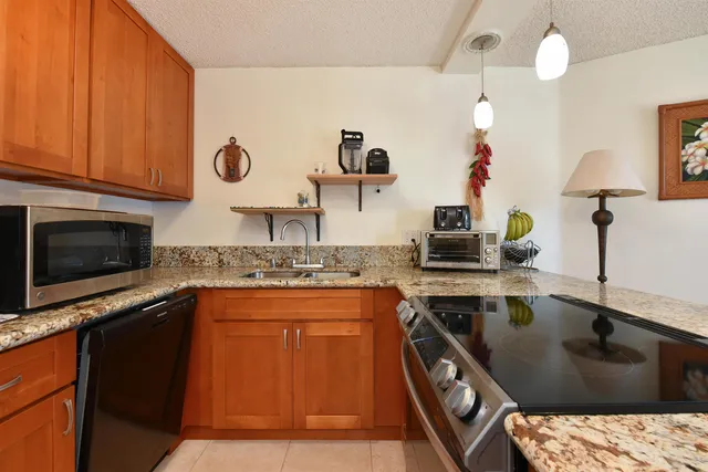 a kitchen with a sink and a stove top oven