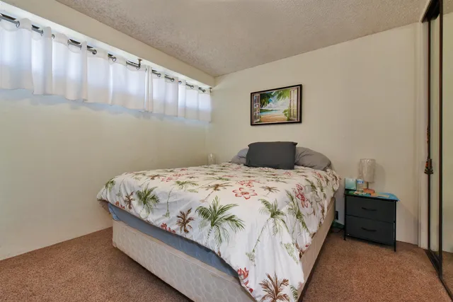 a bedroom with a bed and a night stand