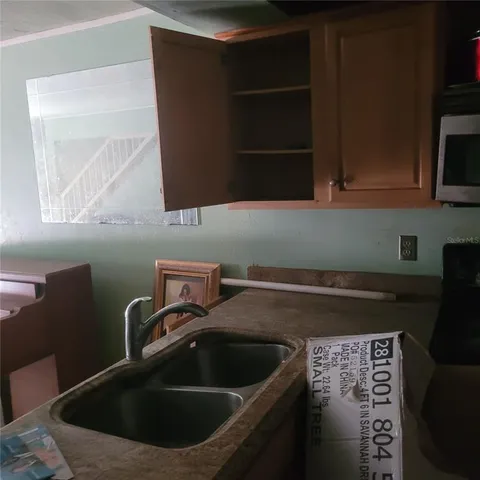 a kitchen with a sink and cabinets
