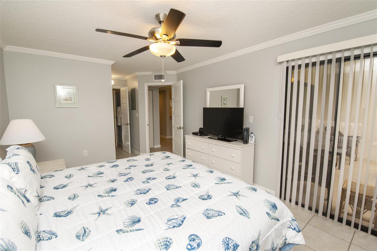 4250 A1A South, Unit A16 St. Augustine, FL 32080 - Photo 12 of 31 a bedroom with a large bed and a flat tv screen