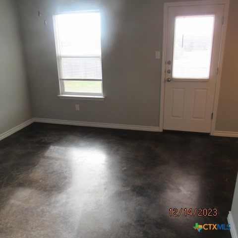 1714 Risen Star Lane, Unit B Copperas Cove, TX 76522 - Photo 4 of 12 an empty room with wooden floor and windows