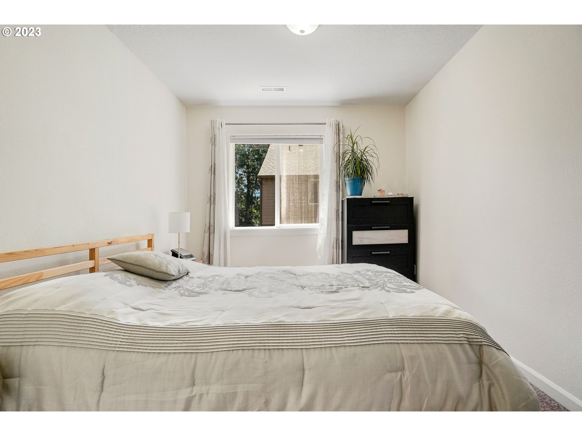 14930 Southwest Conor Circle Beaverton, OR 97006 - Photo 18 of 29 a bedroom with a bed and a window